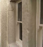 mixture of stone and concrete lintels/surrounds painted with silicate paint