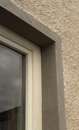  limewashed render and dash with silicate painted lime window surrounds with concrete sills