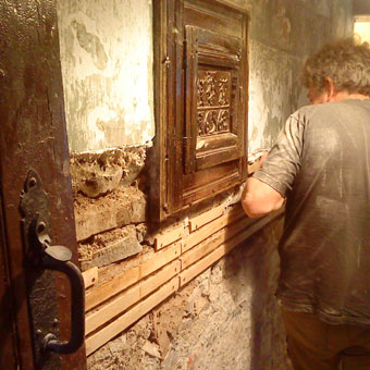lathing over timberwork buried in wall