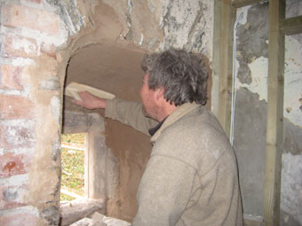 pugging out arched stone mullion window with lime