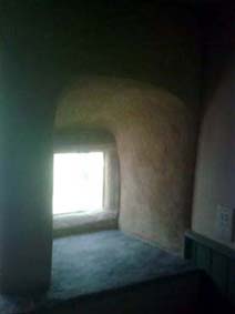 rubbed up lime topcoat on arched stone mullion window