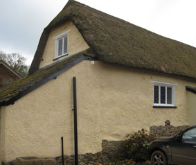 Limewashed thatched cob barn