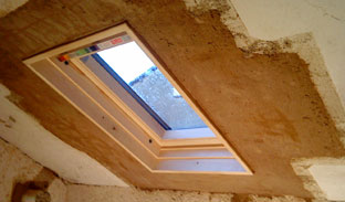layer of coarse lime plaster over repaired lathwork